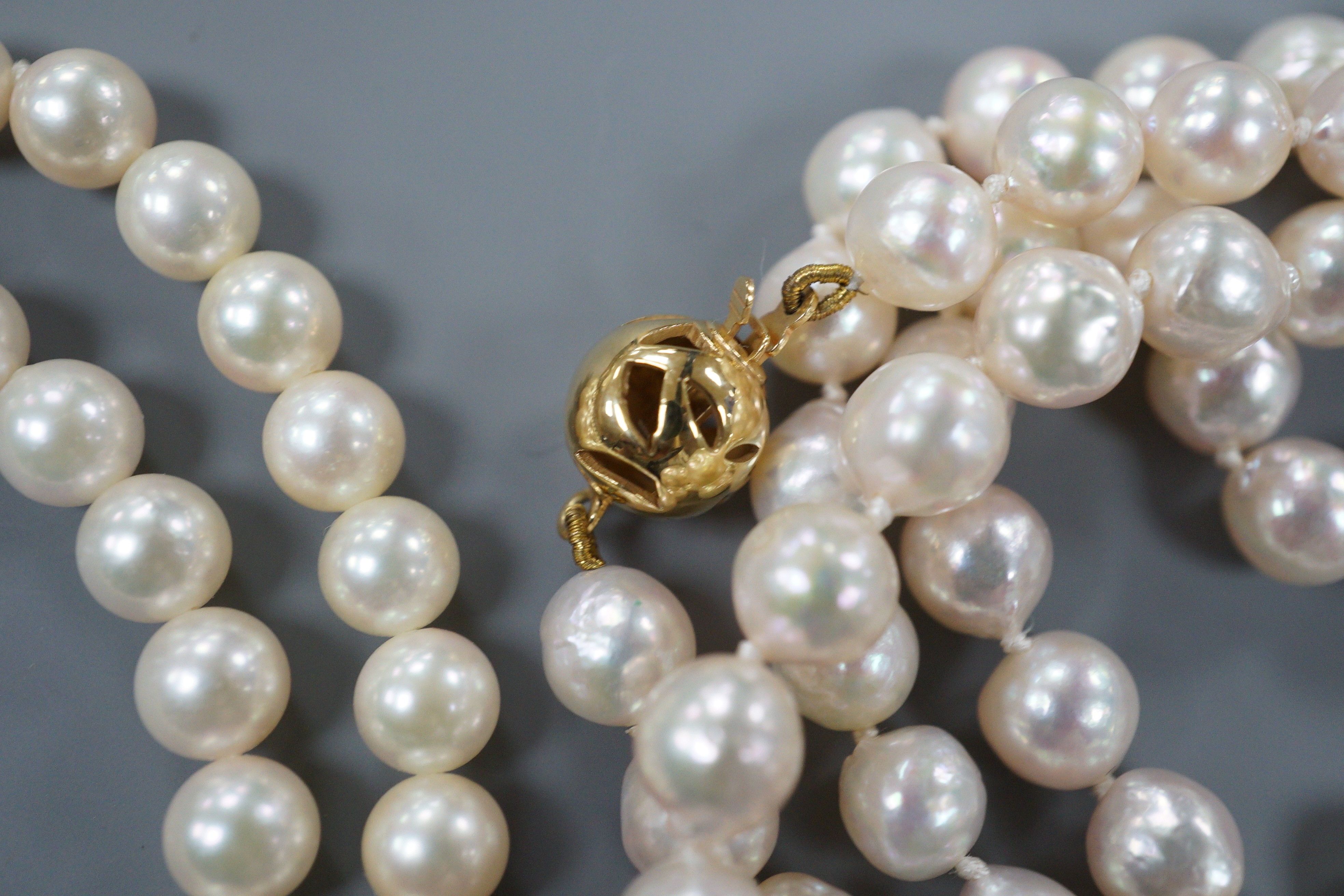 Two single strand cultured pearl necklaces, one possibly freshwater pearl?, both with 9ct gold clasps, largest 74cm.